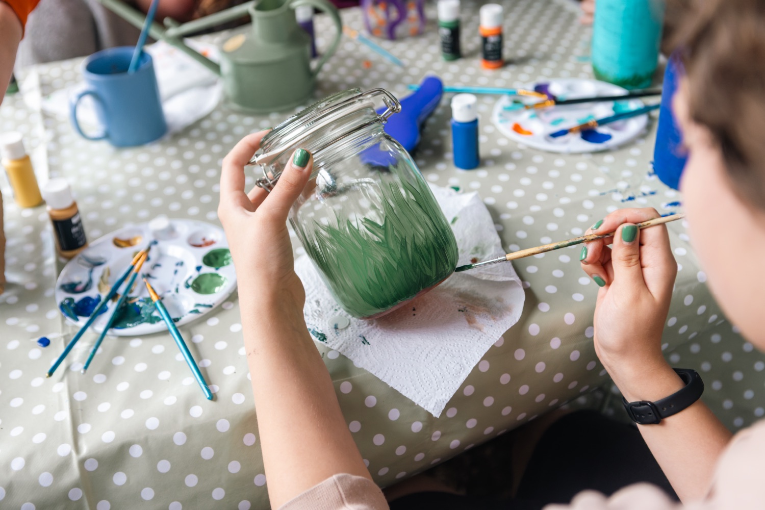 Painting a glass jar at camp