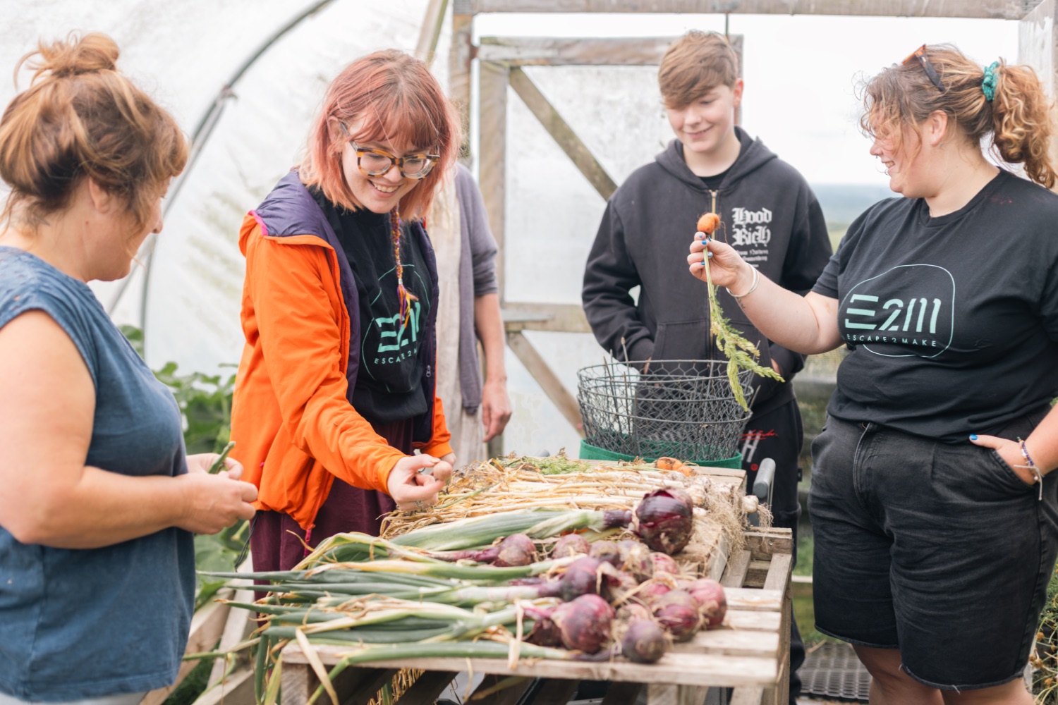 A young person holding foraged onions